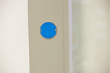 Blue button on the wall