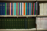 Volumes of books on bookshelf in library