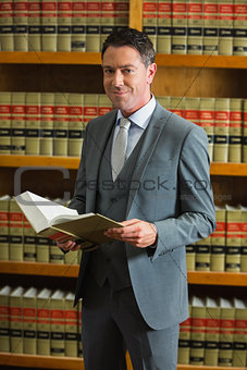 Lawyer holding book in the law library
