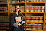 Pretty lawyer looking at camera in the law library