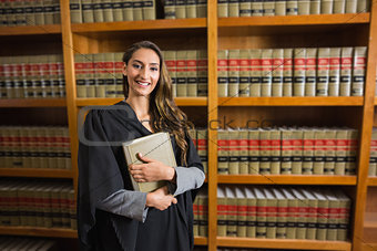 Pretty lawyer looking at camera in the law library