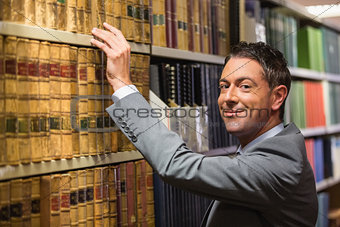 Lawyer picking book in the law library