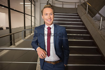 Handsome businessman standing on steps