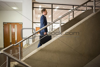 Businessman climbing up the stairs