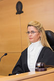 Stern judge sitting and listening