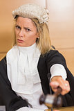 Stern judge pointing her hammer