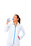 sporty woman drinking water, isolated against white background