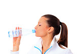 sporty woman drinking water, isolated against white background