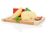 Colorful cheese assortment on chopping board.