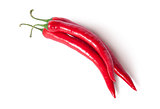 Three red ripe juicy hot chili peppers top view