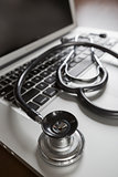 Medical Stethoscope Resting on Laptop Computer