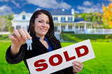 Woman Holding Sold Sign and Keys In Front of House