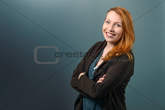 Smiling Red Haired Woman with Arms Crossed