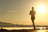 Runner woman silhouette running at sunset