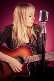 Attractive woman playing acoustic guitar