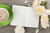 Blank notepad, coffee cup and white rose flowers