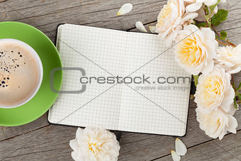Blank notepad, coffee cup and white rose flowers