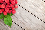 Fresh ripe raspberries on wooden table