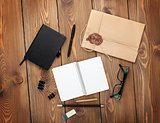 Office table with notepad, vintage envelope and supplies