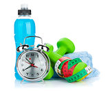 Two green dumbells, tape measure, drink bottle and alarm clock