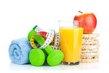 Two green dumbells, tape measure and healthy food. Fitness and h