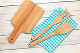 Kitchen utensils over white wooden table background