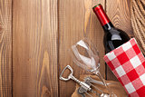 Red wine bottle, wine glass and corkscrew