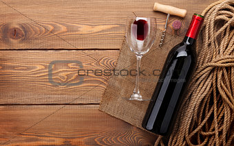 Red wine bottle, wine glass and corkscrew
