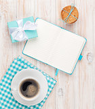 Cup of coffee, gingerbread cookies gift box and notepad