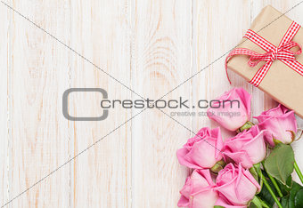 Valentines day background with pink roses and gift box