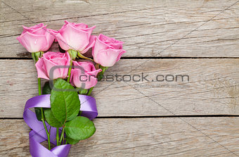 Garden pink roses bouquet over wooden table