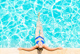 woman relaxes at the edge of the pool