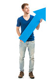 Young man holding a blue arrow