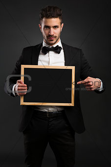 Young man holding a chalkboard
