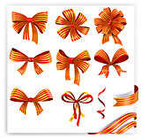 Set of red and gold gift bows with ribbons.