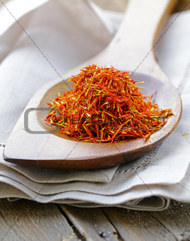 Saffron spice in a wooden spoon macro shot soft focus