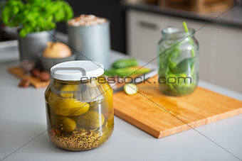 Closeup on jar of pickled cucumbers on table