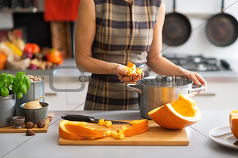 Closeup on young housewife cooking pumpkin