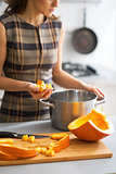 Closeup on young housewife cooking pumpkin