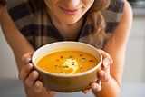 Closeup on young woman enjoying pumpkin soup