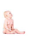 Baby is sitting on floor, isolated on white