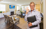 Real Estate Agent with Okay Sign in a Living Room
