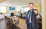 Male Real Estate Agent Holding Keys in Beautiful Living Room
