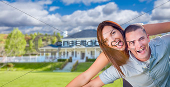 Playful Young Military Couple Outside Beautiful Home