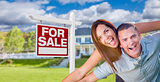 Military Couple In Front of Home with For Sale Sign