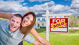 Military Couple In Front of Home with Sold Sign
