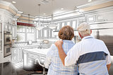 Senior Couple Looking Over Custom Kitchen Design Drawing and Pho
