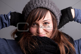 smiling woman posing with hat and warm scarf