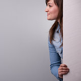profile of a woman showing up behind the wall