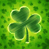 big striped shamrock in green old paper background with flowers